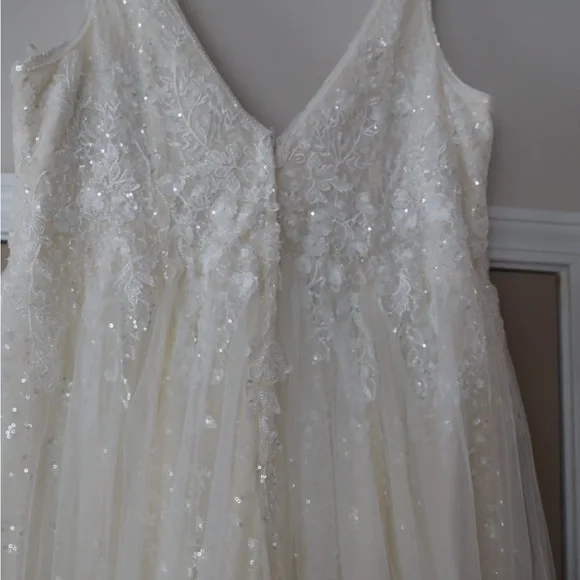 This wedding dress is a size 20. Brand New and had never been worn before.